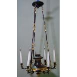 An Empire style gilt and patinated metal six branch chandelier suspended on foliate cast, fluted,
