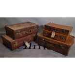 A group of five early 20th century leather bound suitcases, the largest 66cm wide x 18cm high, (5).