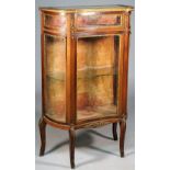A late 19th century French gilt-metal mounted mahogany concave fronted bijouterie cabinet with
