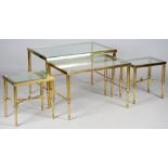 A nest of four mid-20th century lacquered brass and glass inset occasional tables,
