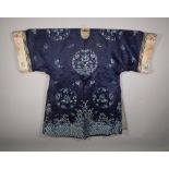 A Chinese silk blue ground robe with all over foliate decoration.
