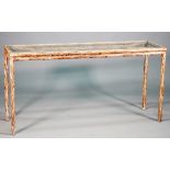 A 20th century console, the rectangular glass inset top on a limed naturalistic carved wood base,