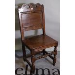 An 18th century and later oak continental chair, on block supports, united by turned stretcher,