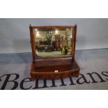 A 19th century mahogany bowfront toilet mirror with three frieze drawers, 52cm wide x 53cm high.