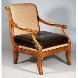 An early 19th century French style faux walnut open armchair, on sabre front supports,