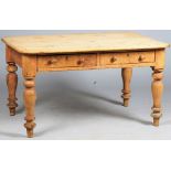 A Victorian pine kitchen table with a pair of frieze drawers on turned supports,