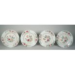 Four Chinese famille-rose plates, Qianlong, each painted in the centre with a vase and flowers,