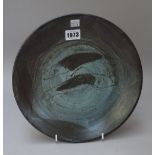 A studio pottery stoneware plate possibly by Bernard Leach, resist decorated with two fish,