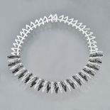 A white gold black diamond and white diamond set fringe necklace and pendent earring suite,