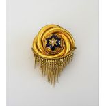 A Victorian gold, half pearl set and enamelled brooch, in an entwined circular design,
