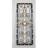 A 20th century parcel gilt and black painted wrought and cast iron rectangular gate,
