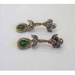 A pair of diamond and emerald pendant earrings, each with an associated drop,