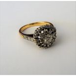 A gold and diamond set circular cluster ring,