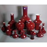 Asian ceramics, a quantity of 20th century red glazed vases of various forms, the largest 42cm high.