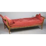 A Louis XVI style gilt framed double scroll end day bed with carved frieze on tapering fluted