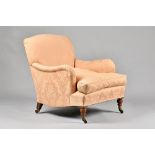 Howard & Son; an easy armchair with downswept arms and shaped side frieze on turned supports,
