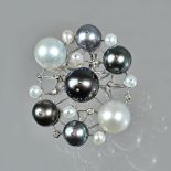 A cultured grey and white pearl and diamond set brooch/pendant, of abstract circular design,