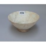 A Kashan white glazed pottery bowl, probably 12th century, raised on short foot, (a.f), 16.5cm.