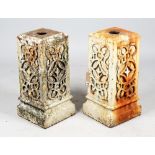 A pair of white painted wrought iron pedestals, with relief wriggle work mounts,