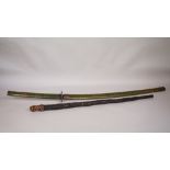 A South East Asian hardwood walking stick, the finial carved as the head of a sage,