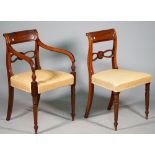 A set of eight George IV mahogany dining chairs with double pierced waist rail on turned supports,