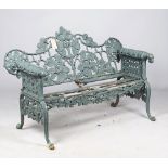 After Coalbrookdale; an oak and ivy pattern green painted cast iron garden bench,