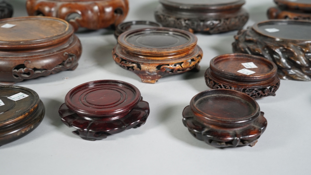 A group of nineteen Chinese wood stands, 19th/20th of various forms, 9cm to 25cm diameter, (19). - Image 3 of 6