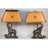 A pair of modern composite bronze elephant table lamps, each with brown leather shades,