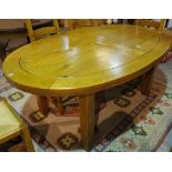 A 20th century oak oval extending dining table, 115cm wide x 185cm long x 265cm fully extended,
