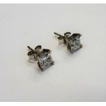 A pair of diamond single stone earstuds, each claw set with a princess cut diamond,