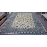 A Kashan carpet, Persian, the ivory field with an allover palmette and floral vine design,