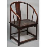 An early 20th century Chinese hardwood horseshoe back armchair with woven seat on rounded supports,