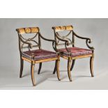 In the manner of Thomas Hope; a pair of Regency parcel gilt ebonised open armchairs,
