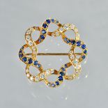 A gold, sapphire and diamond brooch, in an interlooped shaped circular design,