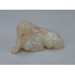 A Chinese small white jade mythical creature, carved in recumbent pose, 5.5cm.length.