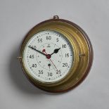 A ship's brass capstan timepiece With white-painted dial, sweep centre seconds and Admiralty arrow,
