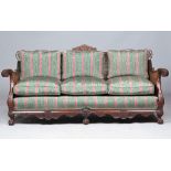 An early 20th century carved mahogany double bergere suite to comprise; a sofa,