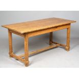 A 19th century pine kitchen table, the single plank top on four canted square supports,