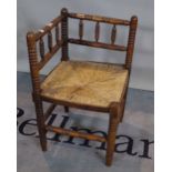 A 19th century turned beech rush seated corner chair, 41cm wide x 69cm high.
