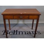 A 19th century oak foldover tea table with single drawer tapering square supports.