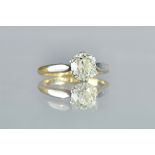 A gold and platinum, diamond set single stone ring, claw set with a cushion shaped diamond,