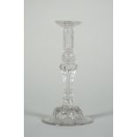 A glass taperstick, mid-18th century, the nozzle with wide drip pan moulded with flutes,