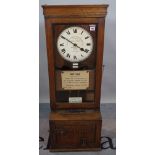 The Gledhill-Brook Time Recorders, an oak cased clocking in machine, 134cm high.