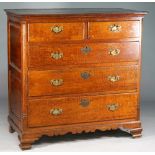 A mid-18th century Lancashire oak chest of two short over three long graduated drawers flanked by