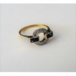 A gold and platinum, diamond and sapphire set ring, in an openwork circular design,