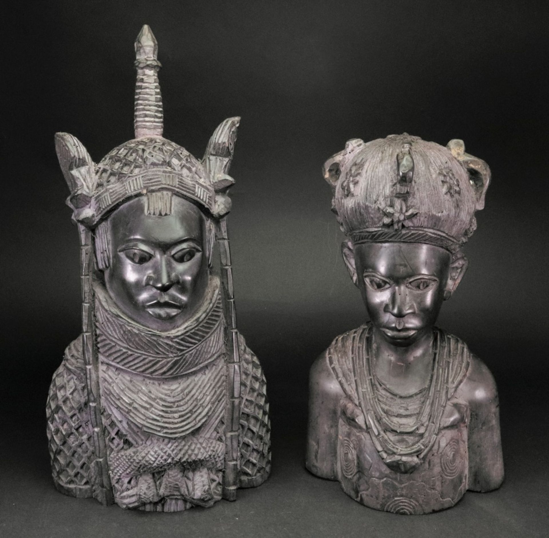 A pair of 20th century Nigerian wood carvings of a man and a woman, one 41cm high,