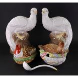 A pair of Studio pottery figures of peacocks, 20th century, perched on rock work, 27cm high,