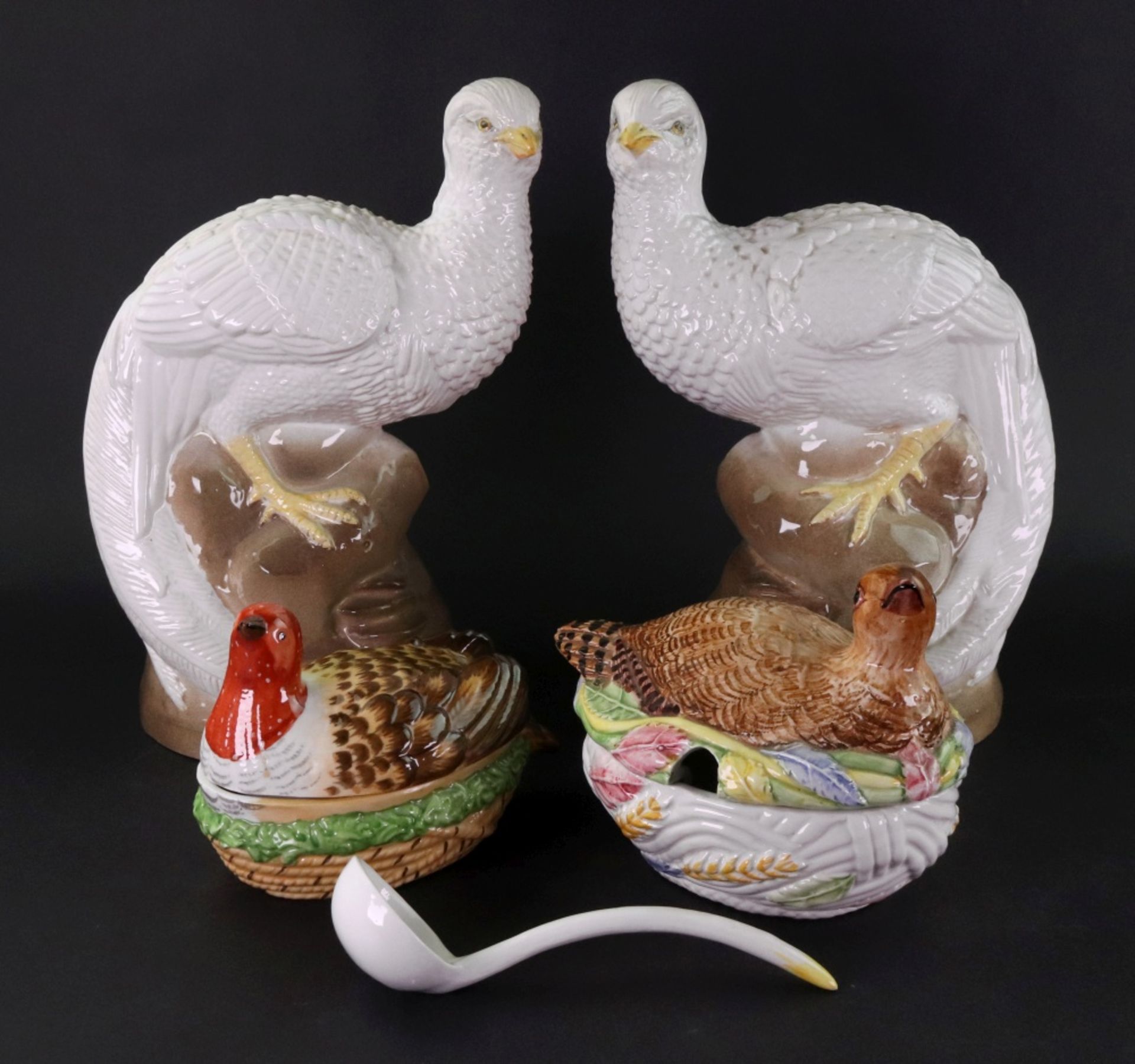 A pair of Studio pottery figures of peacocks, 20th century, perched on rock work, 27cm high,