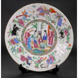 A Canton famille rose dish, mid 19th century, painted with a central figurative panel,