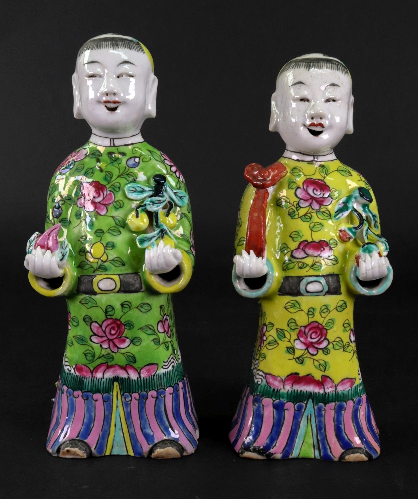 A pair of Chinese famille rose figures of boys, late 19th/20th century,